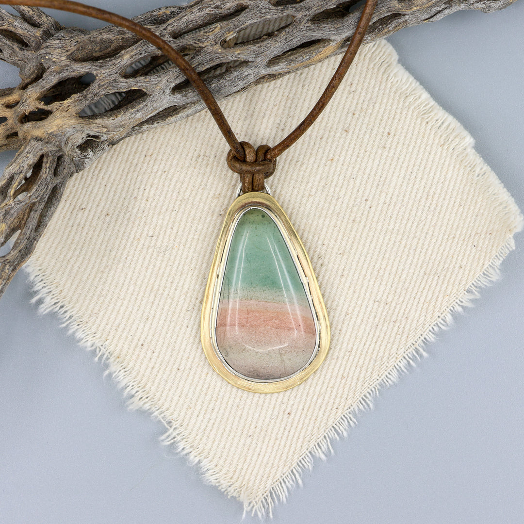 handmade, one of a kind jasper, brass, and silver pendant on a leather cord