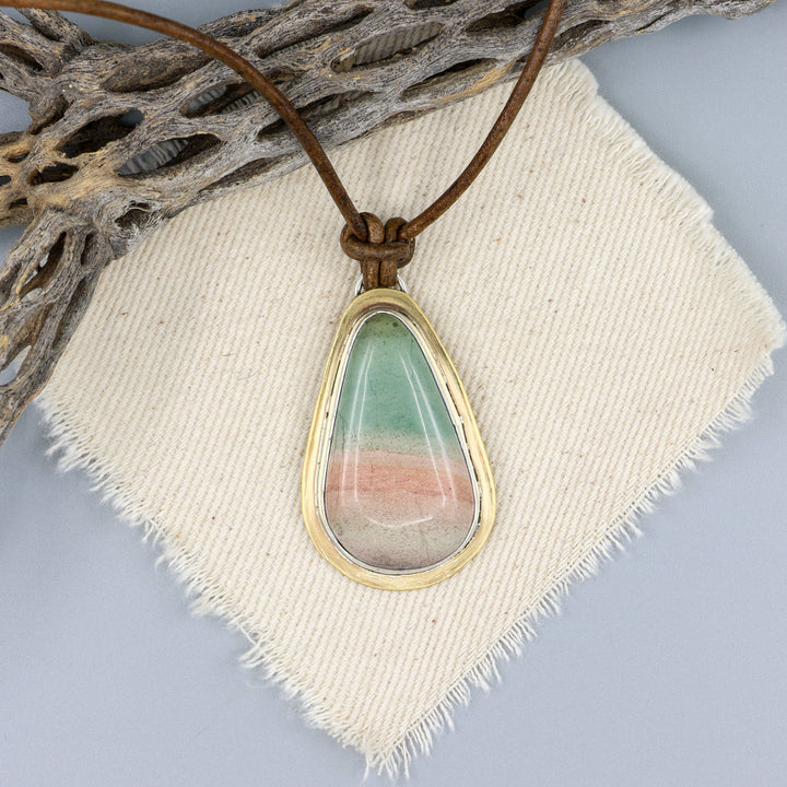 handmade, one of a kind jasper, brass, and silver pendant on a leather cord