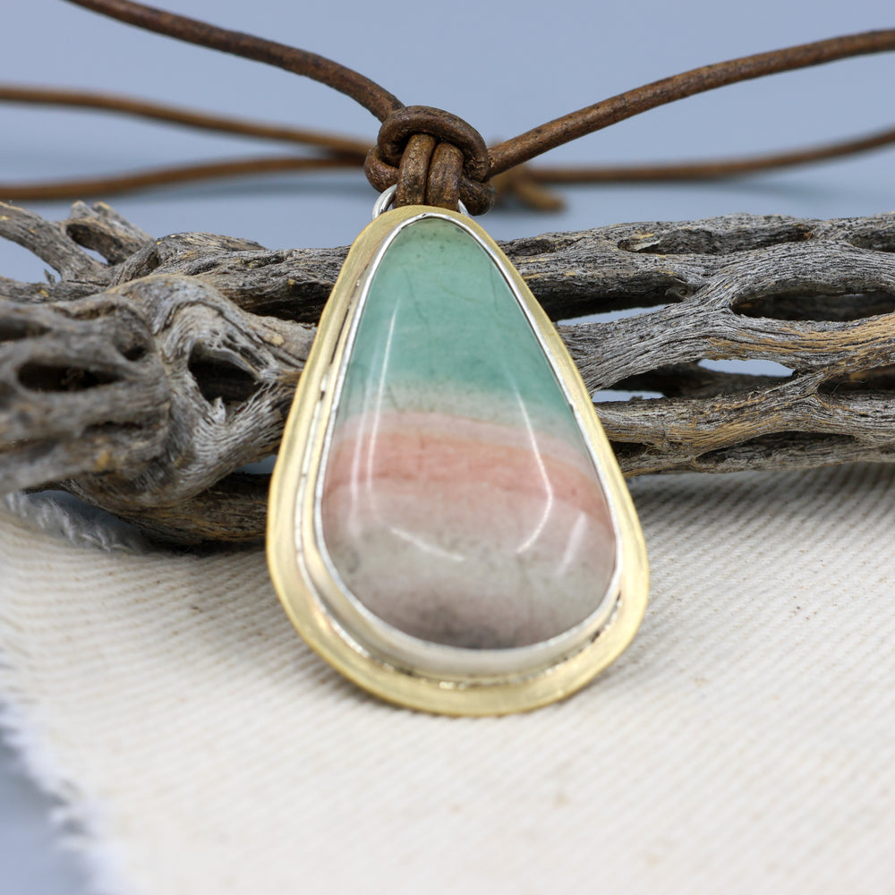 handmade, one of a kind jasper, brass, and silver pendant on a leather cord