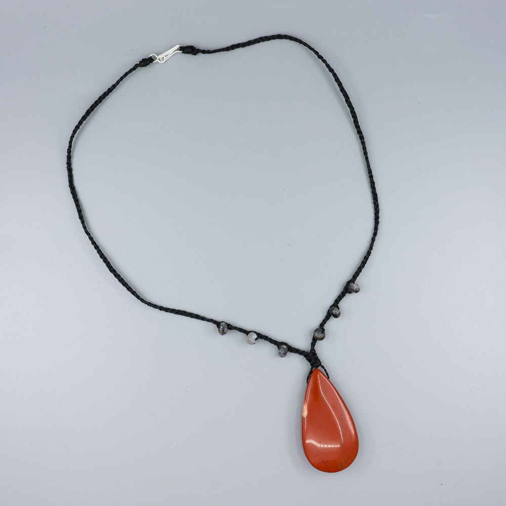 red jasper & larvikite bradied necklace with sterling silver clasp on a gray background