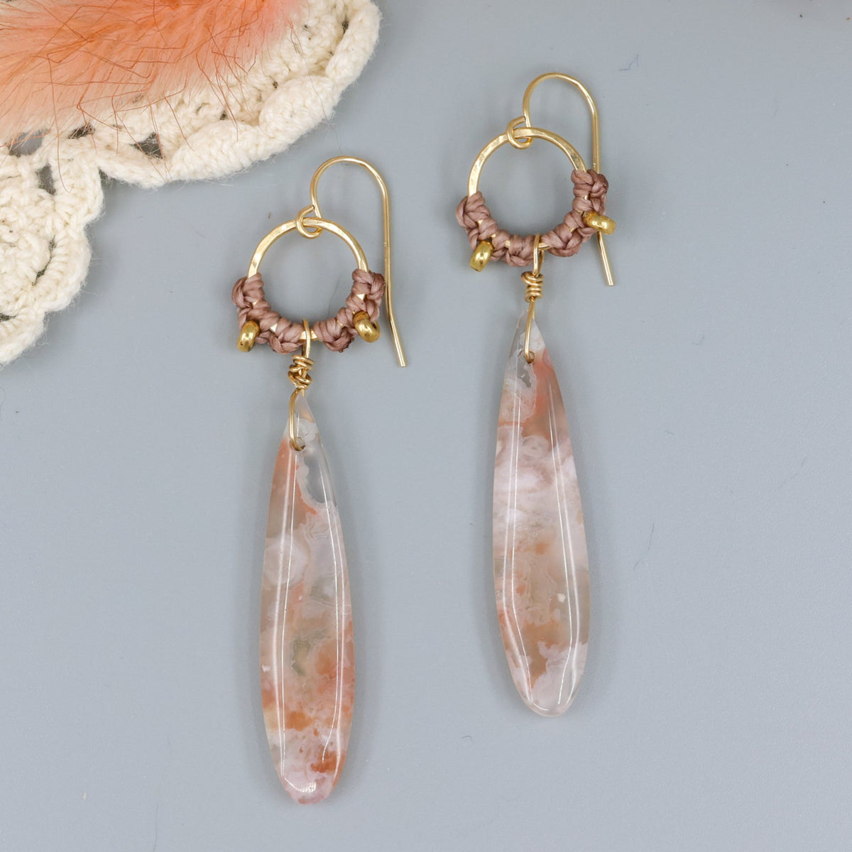 cherry blossom agate handmade macrame hoop earrings in gold fill on a gray background