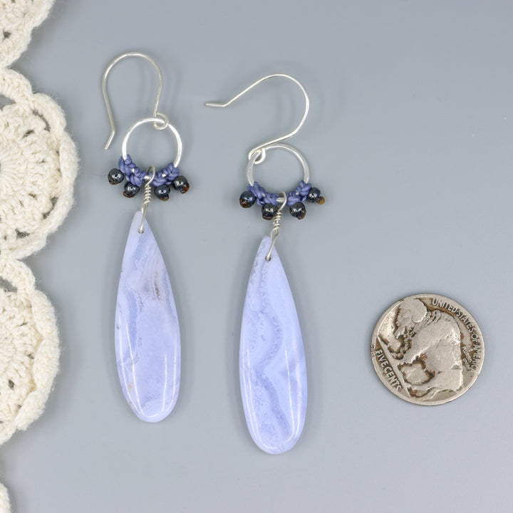 handmade, sterling silver and blue lace agate dangle earrings with a nickel for size comparison