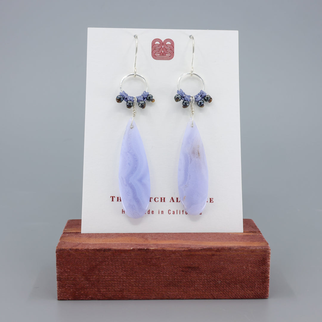 handmade, sterling silver and blue lace agate dangle earrings on a white card