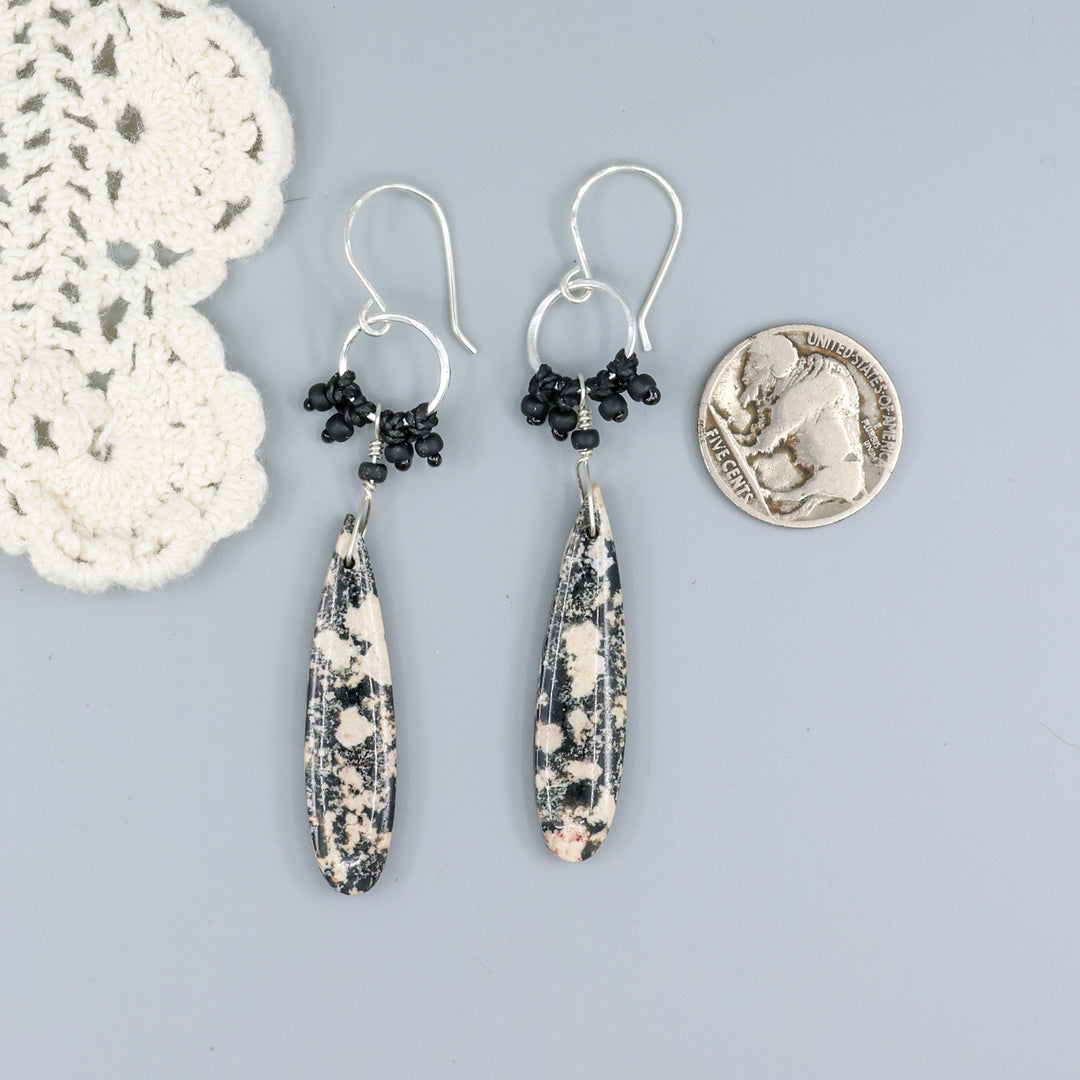 handmade snowflake obsidian sterling silver macrame earrings with a nickel for size comparison