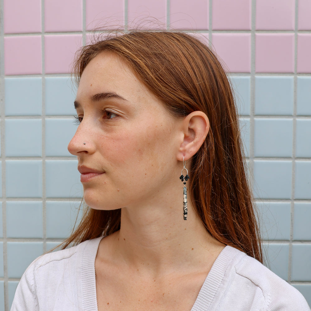 snowflake obsidian sterling silver statement earrings worn on a model