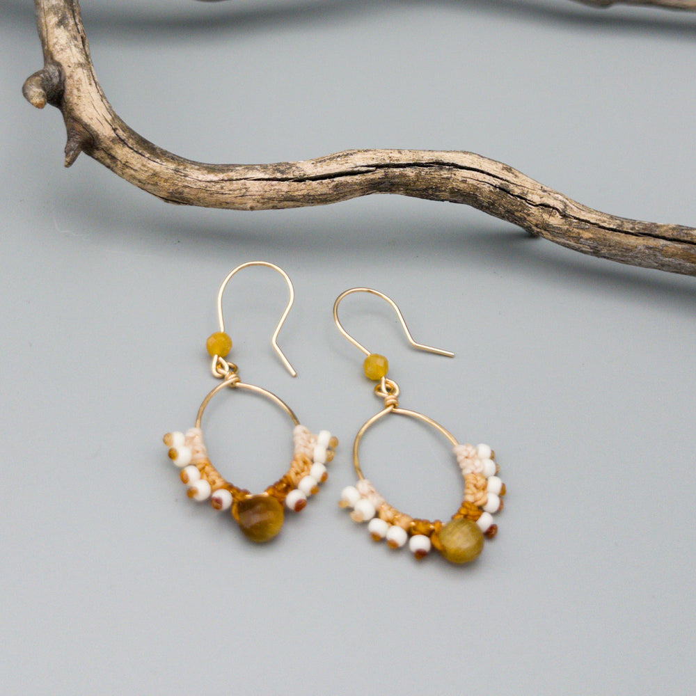 gold filled hoop earrings macrame with golden tiger eye faceted beads on a gray background
