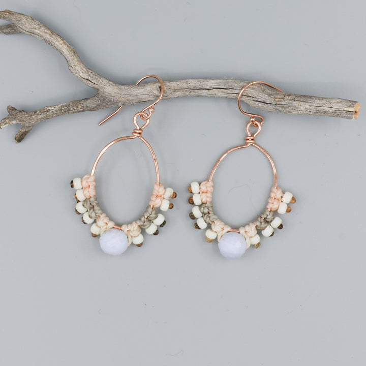 handmade rose gold hoop earrings with blue lace agate bead and macrame on gray background