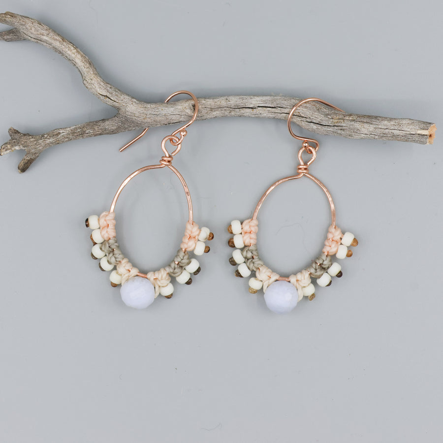 handmade rose gold hoop earrings with blue lace agate bead and macrame on gray background