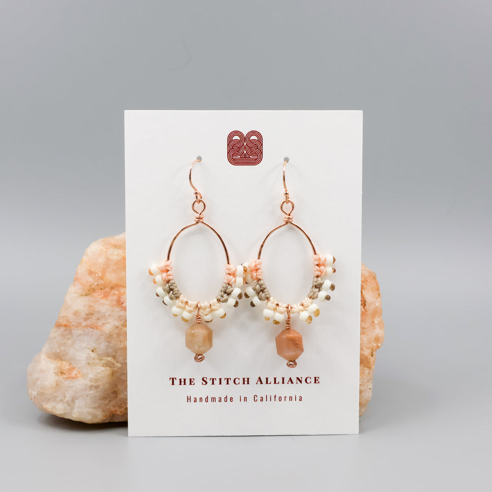 peach moonstone & rose gold macrame hoop earrings on a white card