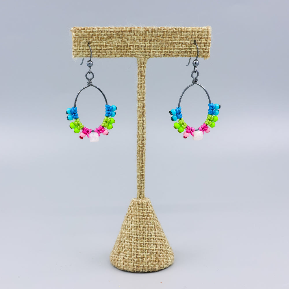 handmade macrame hoop earrings in oxidized sterling silver with bright colors and rainbow moonstone bead on a linen hanger