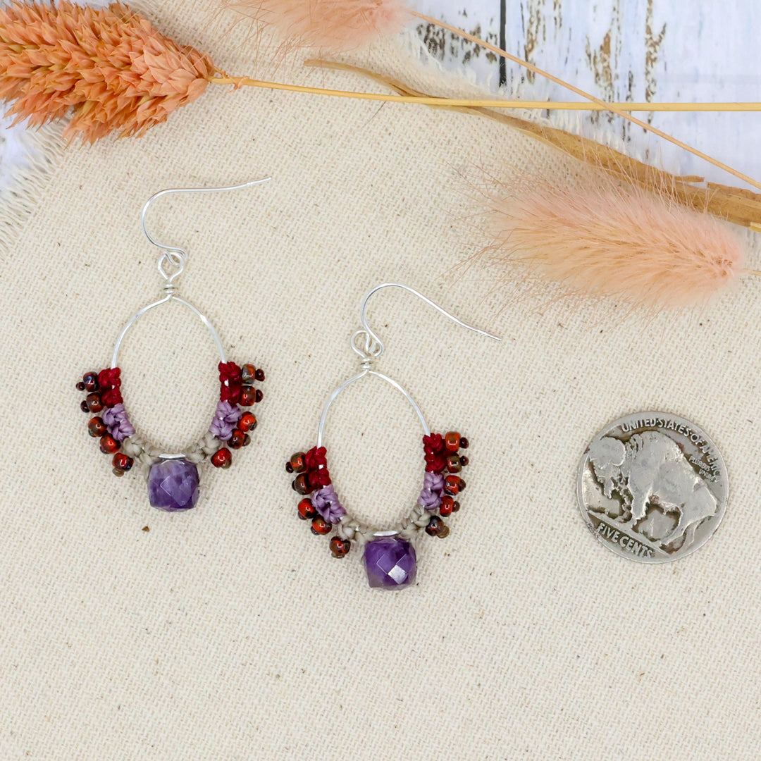 handmade sterling silver and amethyst hoop earrings with macrame shown with a coin for size comparison