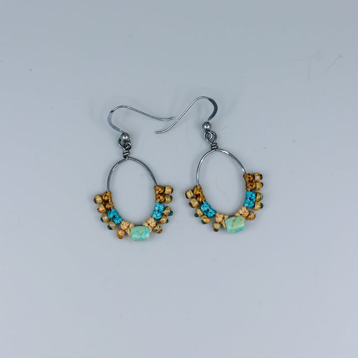 turquoise macrame hoop earrings on a gray background