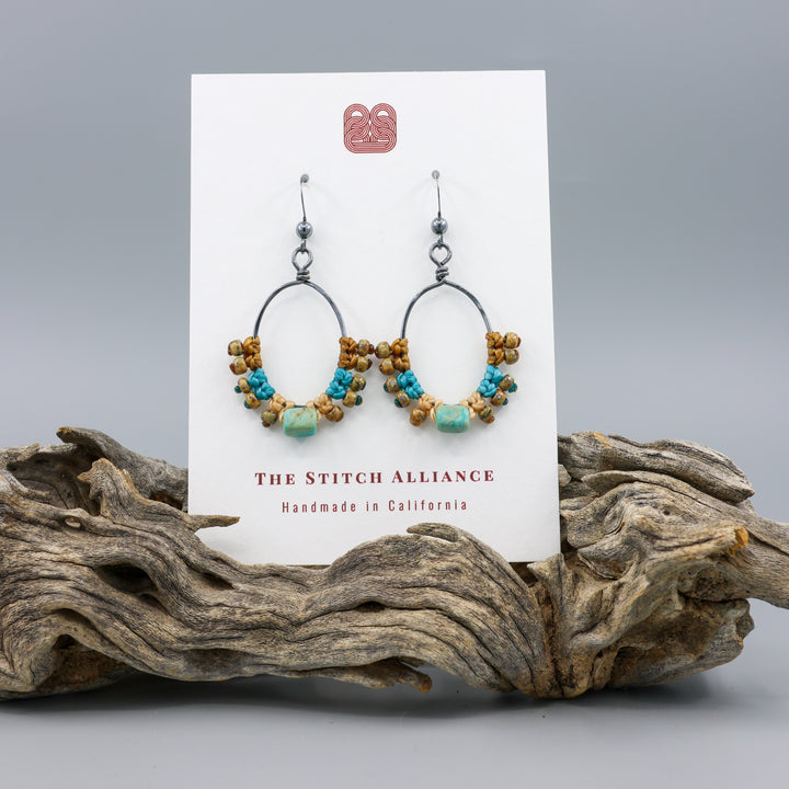 turquoise macrame hoop earrings on a white card