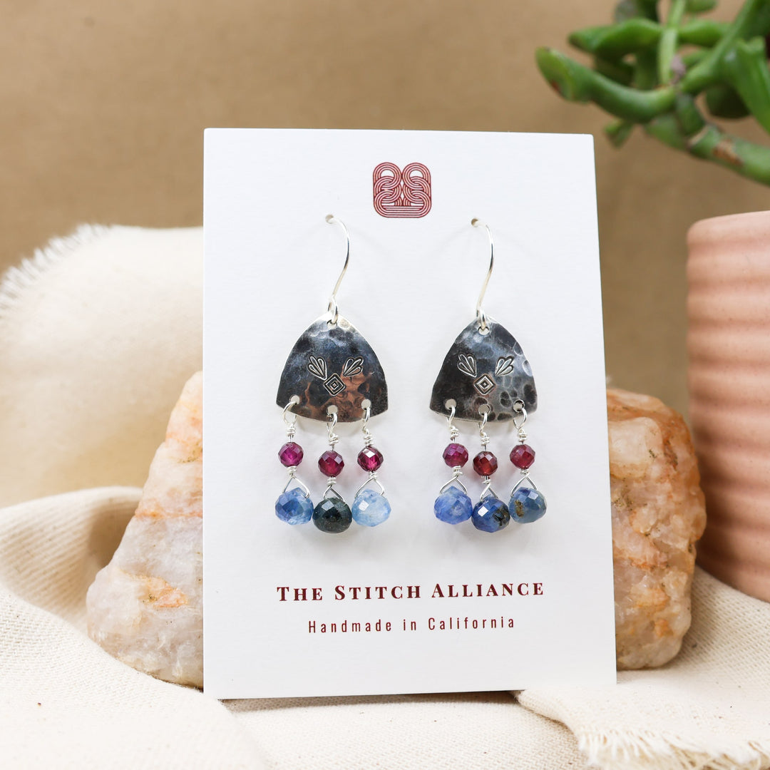 kyanite, garnet, sterling silver handmade earrings on a white card