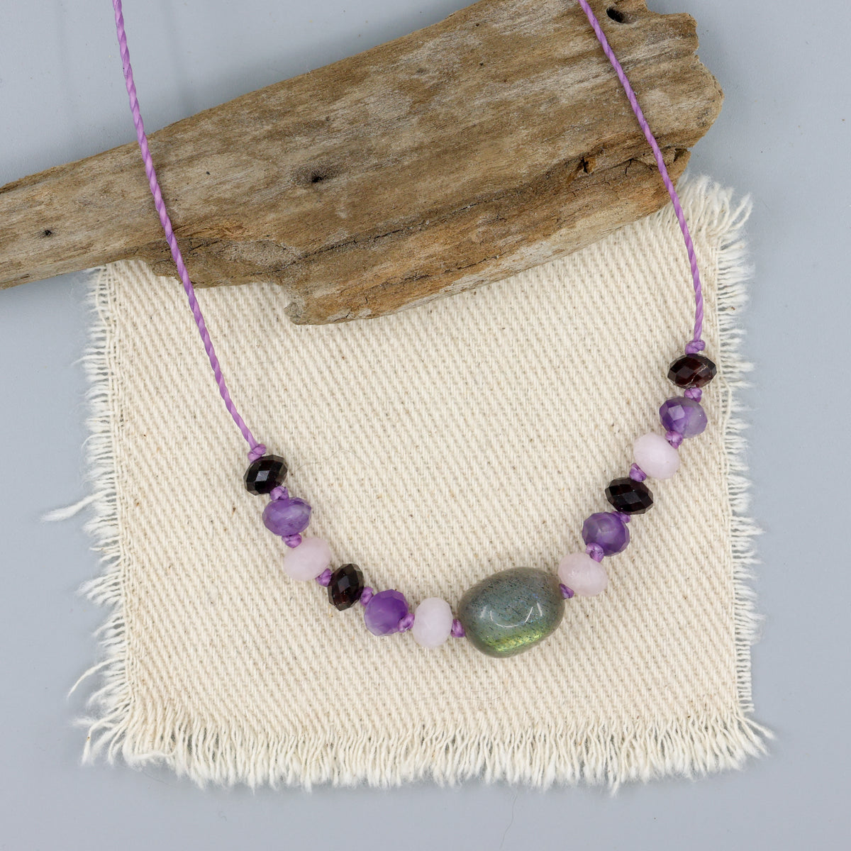 handknotted labradorite, morganite, amethyst, and garnet necklace with purple cord