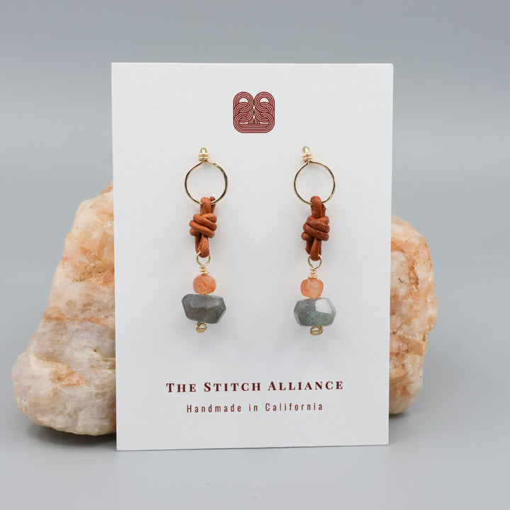 labradorite, sunstone, leather 14k fill handmade earrings shown on a white card