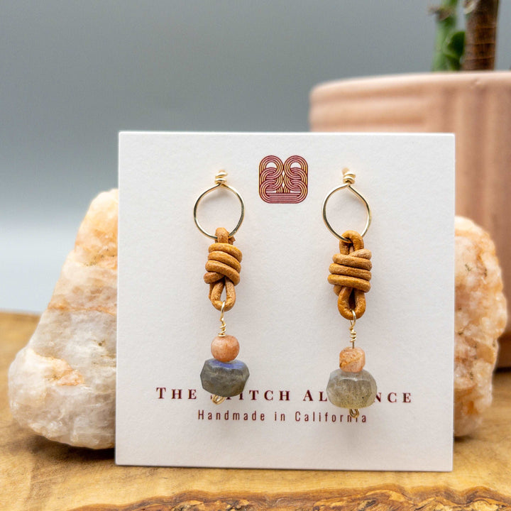 Labradorite, sunstone, leather and gold fill drop earrings on a white card