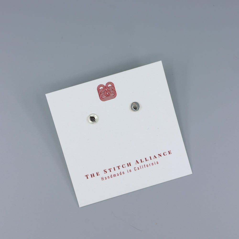 leaf stamp small sterling silver stud earrings on a white card