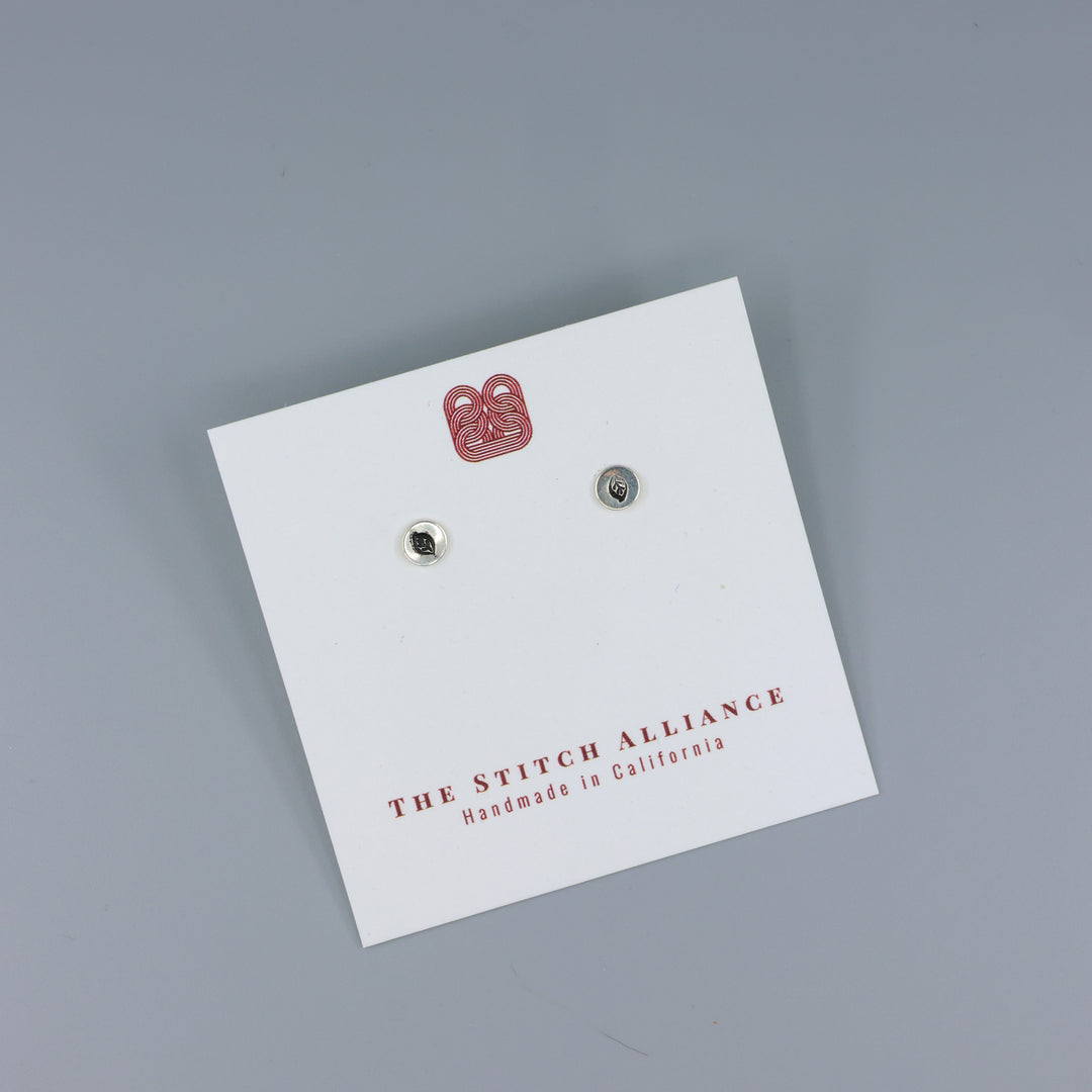 leaf stamp small sterling silver stud earrings on a white card