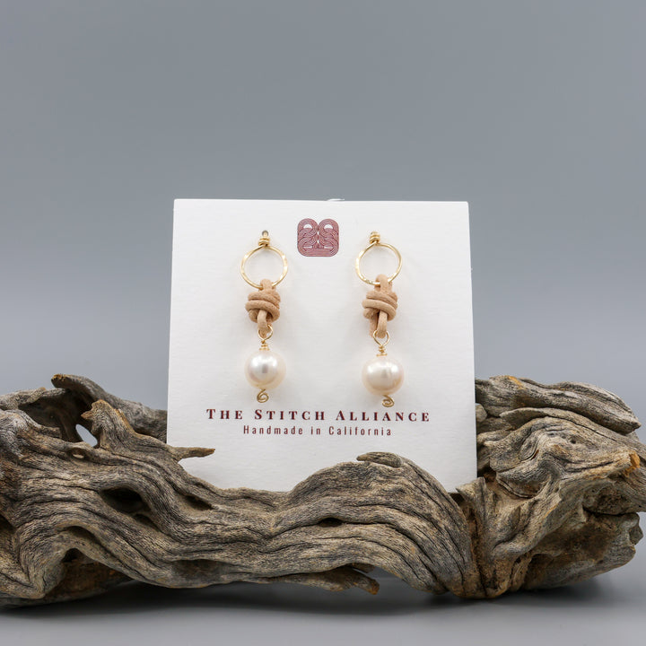 freshwater pearl, leather, and gold fill handmade earrings on a white card