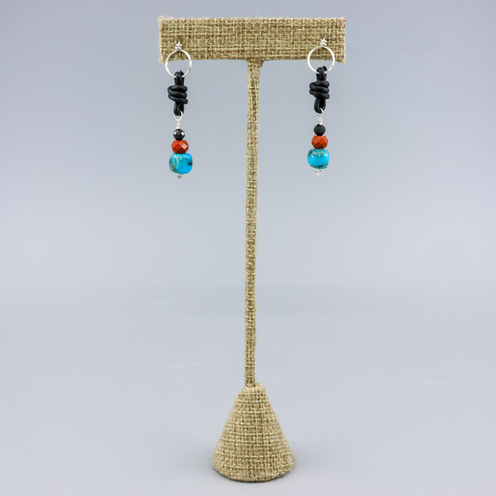 turquoise, poppy jasper, and spinel leather knotted earrings with sterling silver on a linen hanger