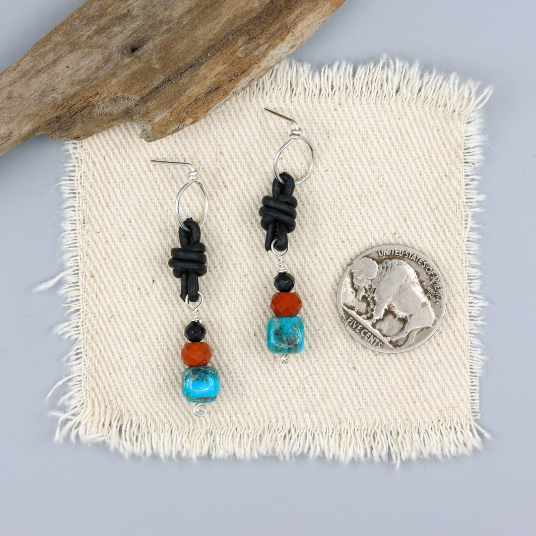 turquoise, poppy jasper, and spinel leather knotted earrings with sterling silver with a nickel for size comparison