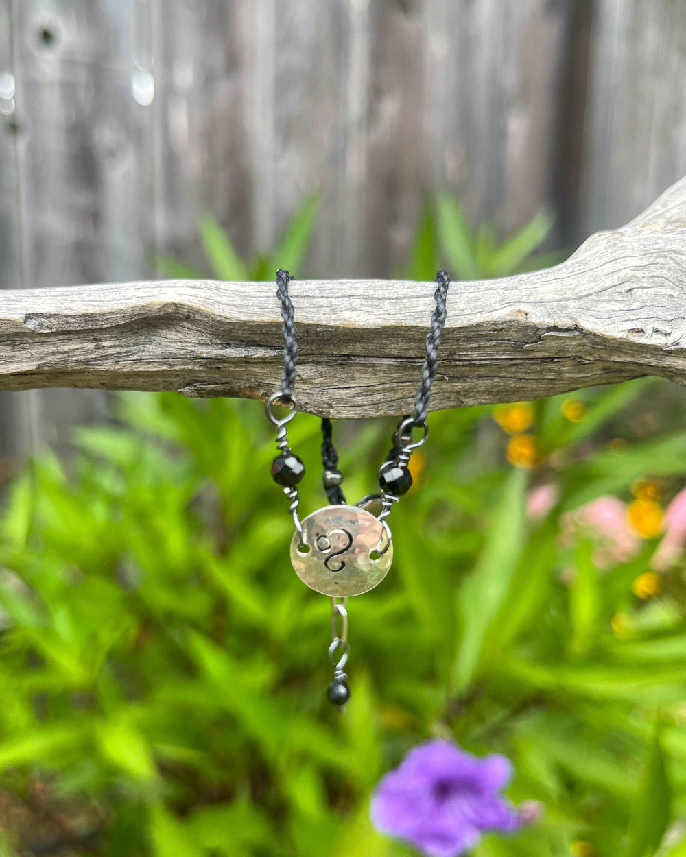 Silver Leo stamped bracelet with black spinel beads