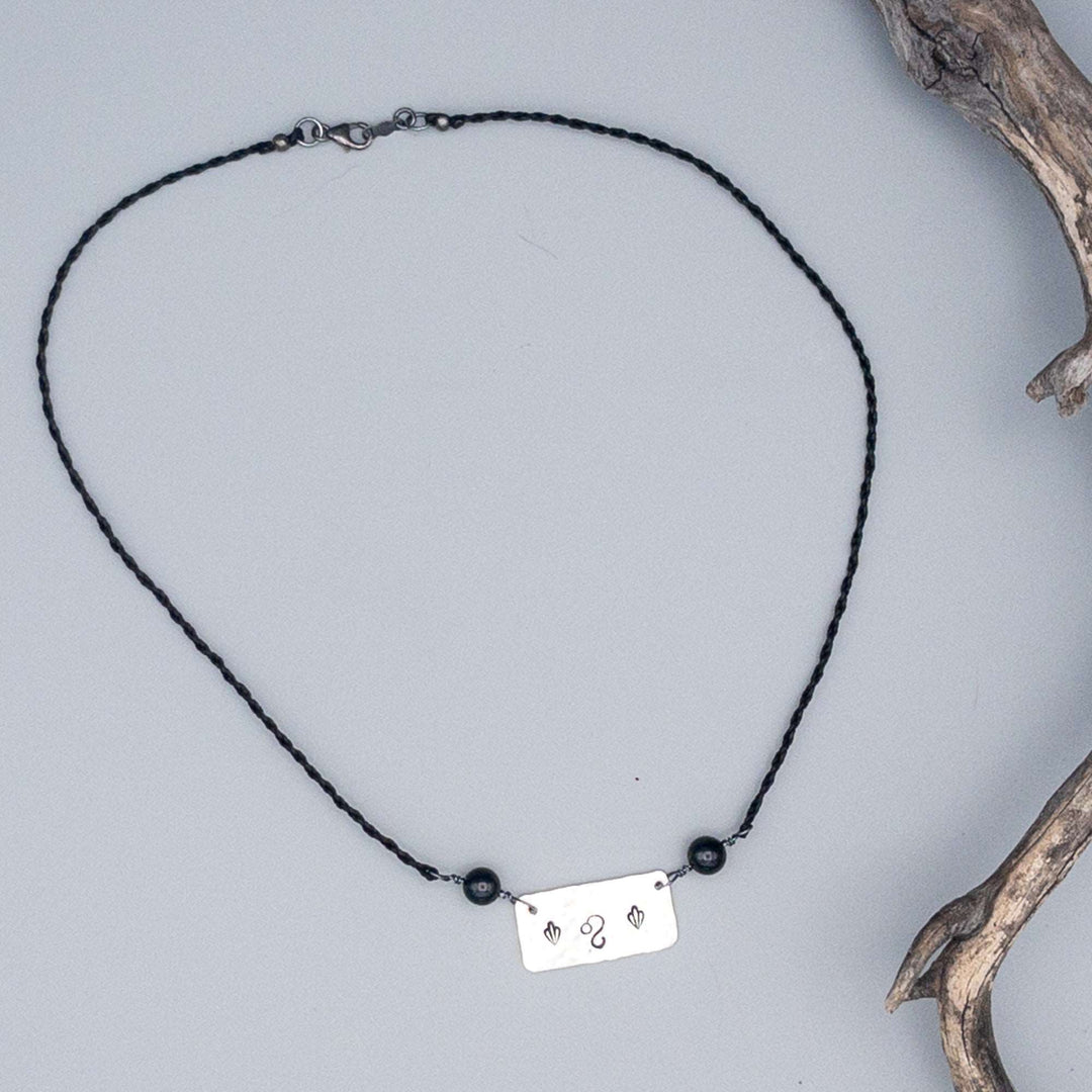 Leo stamped sterling silver necklace with black spinel beads