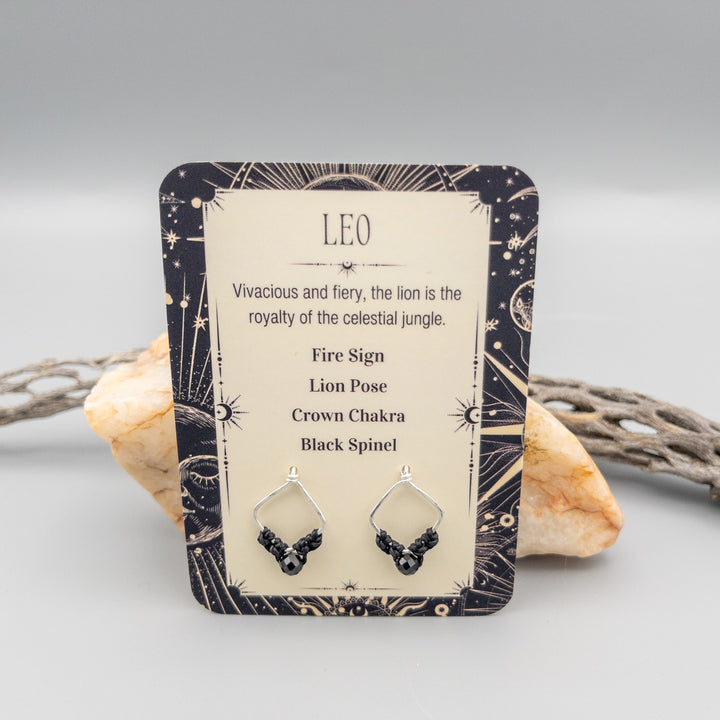 Leo black spinel sterling silver earrings showing the front of the card