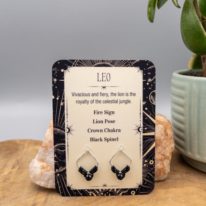 Leo black spinel sterling silver earrings on a gift card