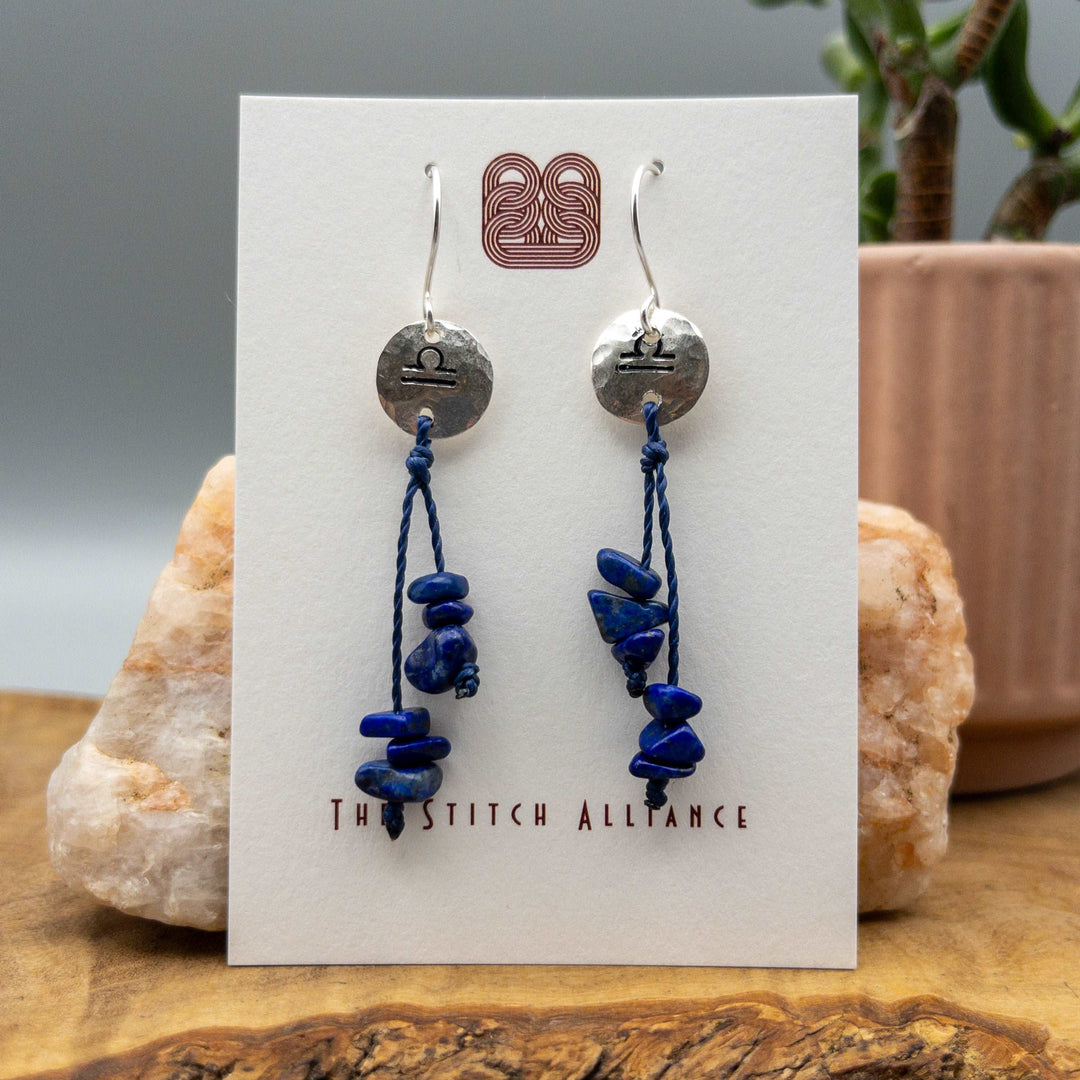 Libra zodiac earrings hand stamped sterling silver with lapis lazuli beads on a white background