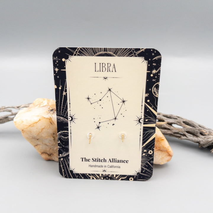 Libra gold filled peridot earrings showing the back of the card