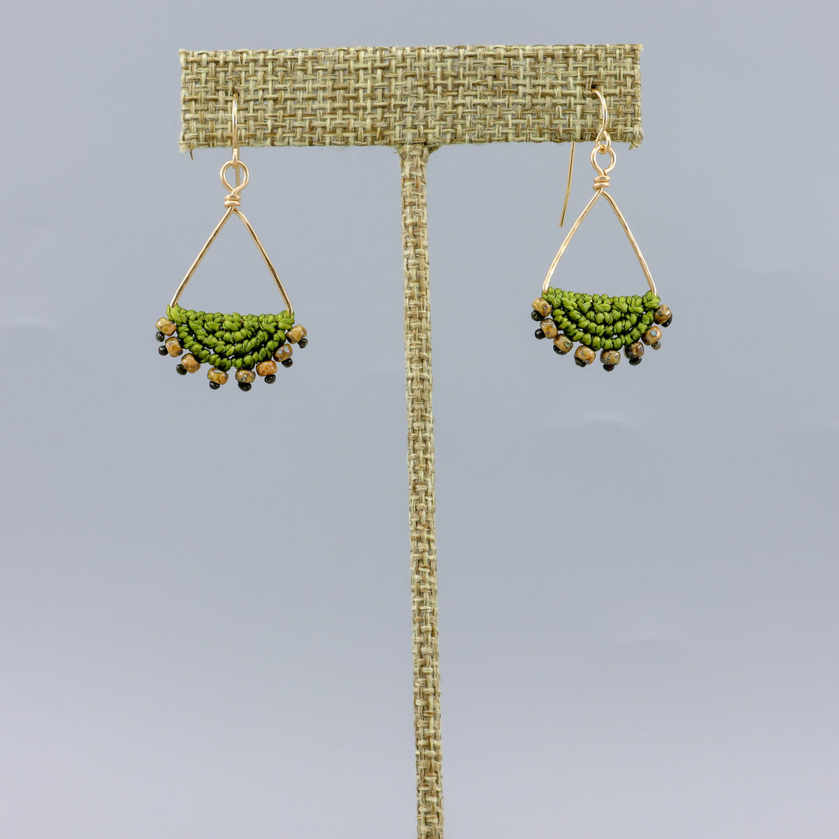 handmade macrame triangle hoop earrings gold fill olive green color on gray background