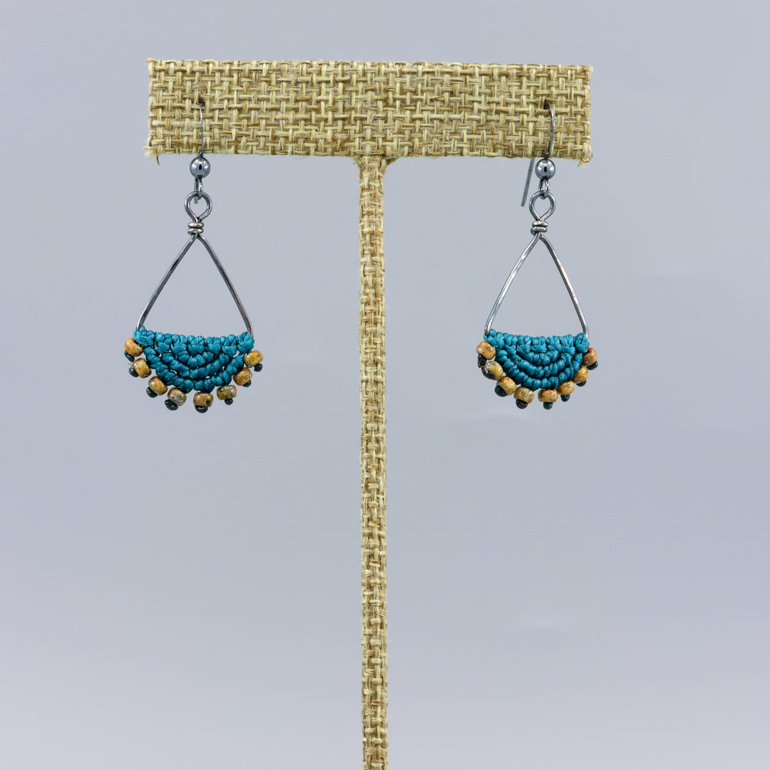 handmade macrame triangle hoop earrings oxidized sterling silver teal color on a gray background