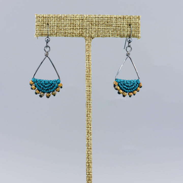 handmade macrame triangle hoop earrings oxidized sterling silver teal color on a gray background