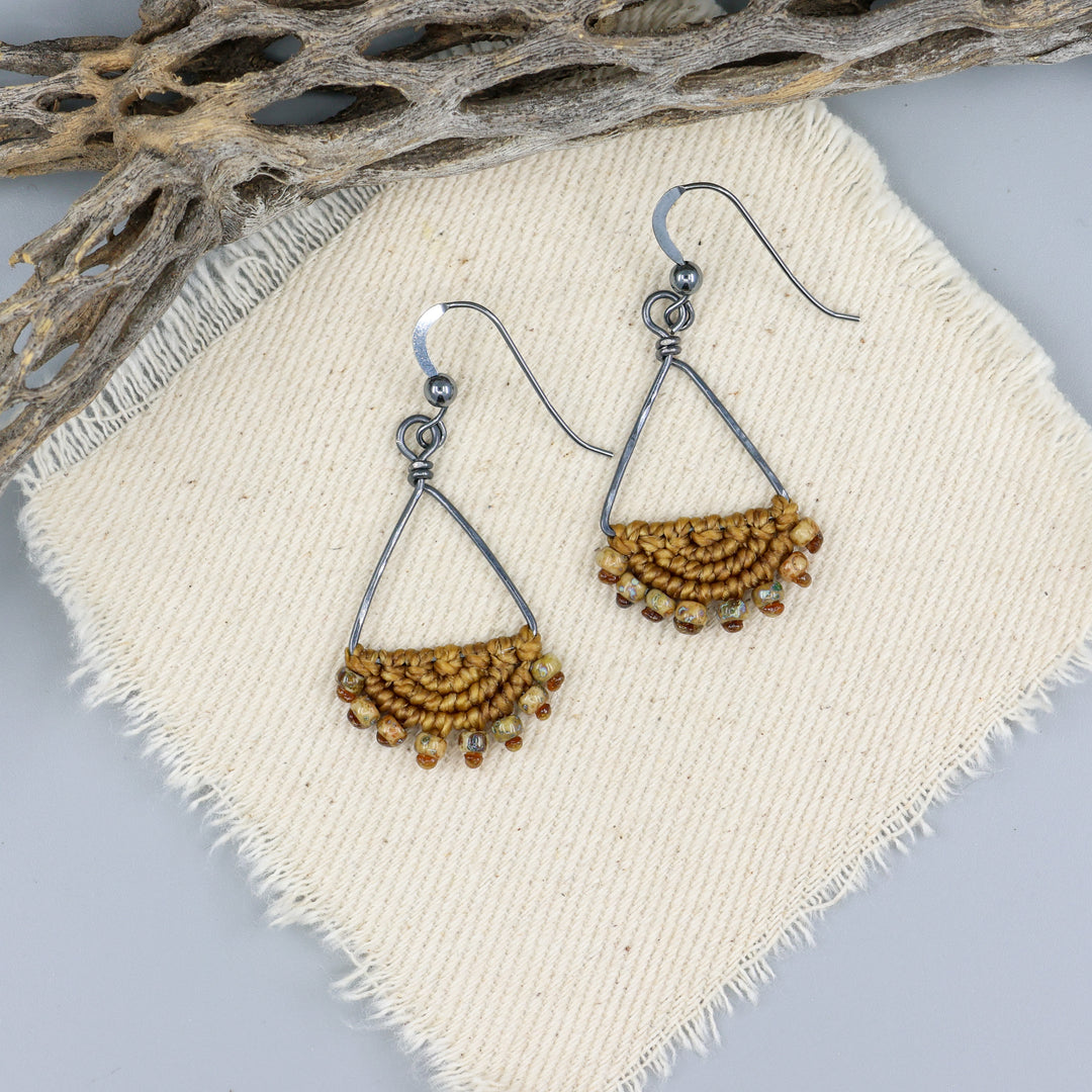 handmade macrame triangle hoop earrings oxidized sterling silver old gold color on an off white background