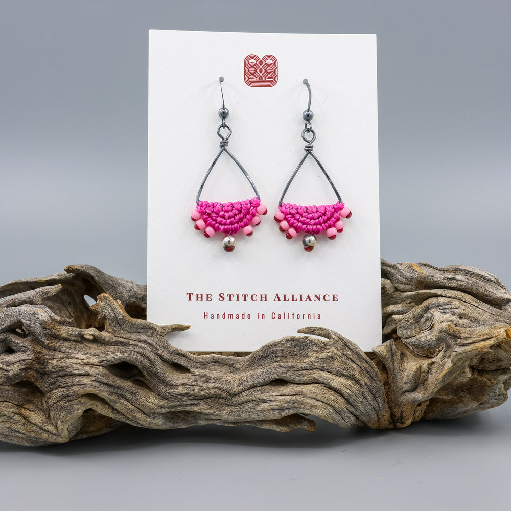 handmade oxidized sterling silver triangle hoop earrings with bright pink macrame on a white card