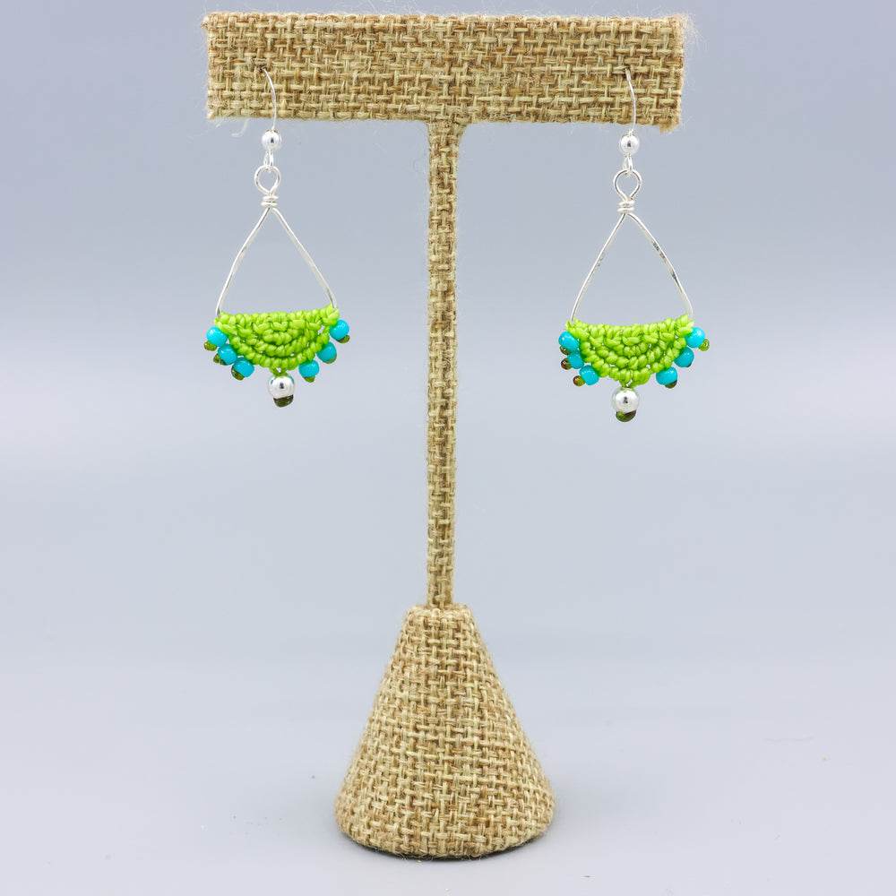 handmade sterling silver triangle hoop earrings with lime green macrame on a linen hanger