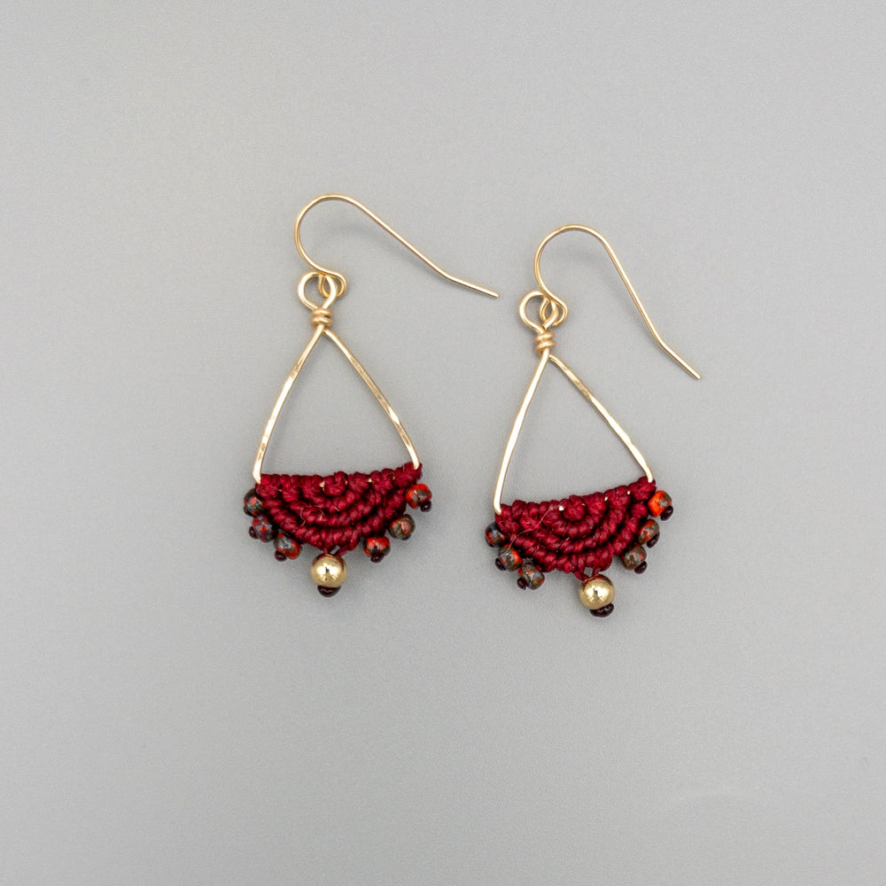 Macrame triangle hoop earrings gold fill deep red on a gray background