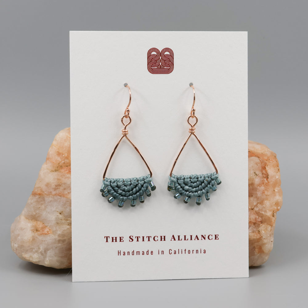 rose gold triangle macrame earrings on a white card