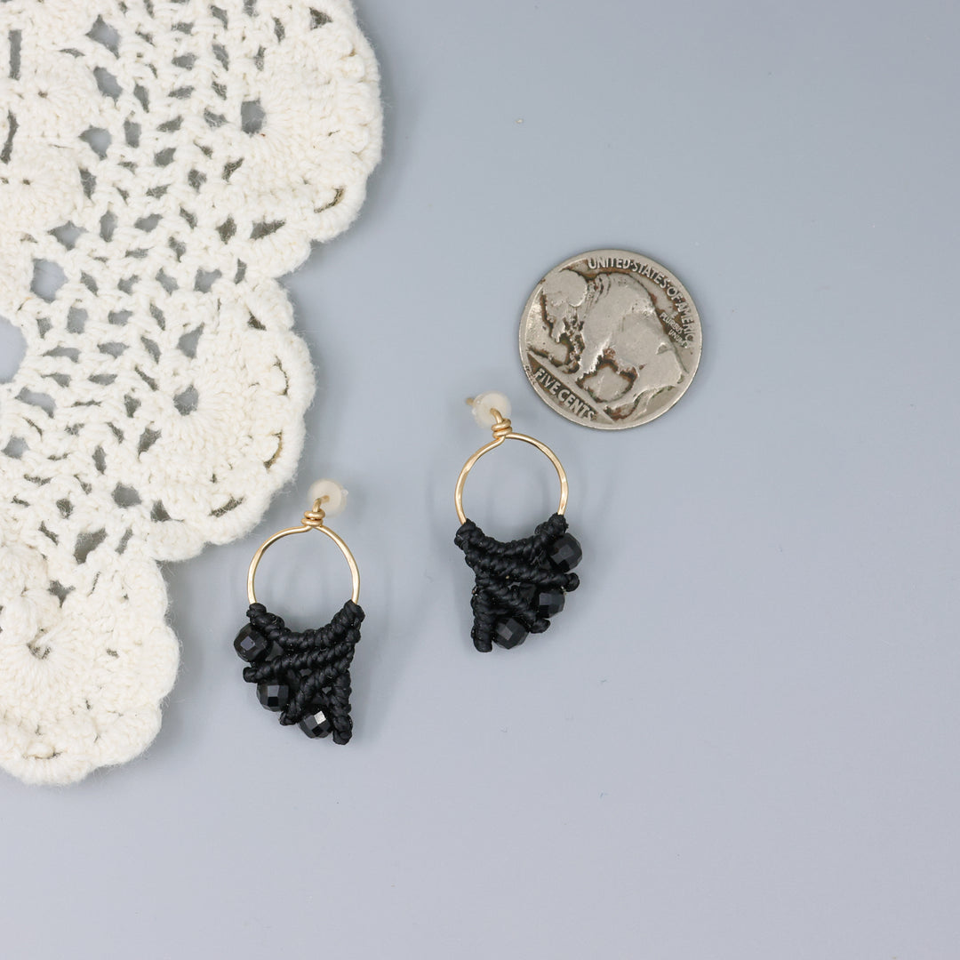 handmade gold fill macrame earrings with black spinel beads with a nickel for size comparison