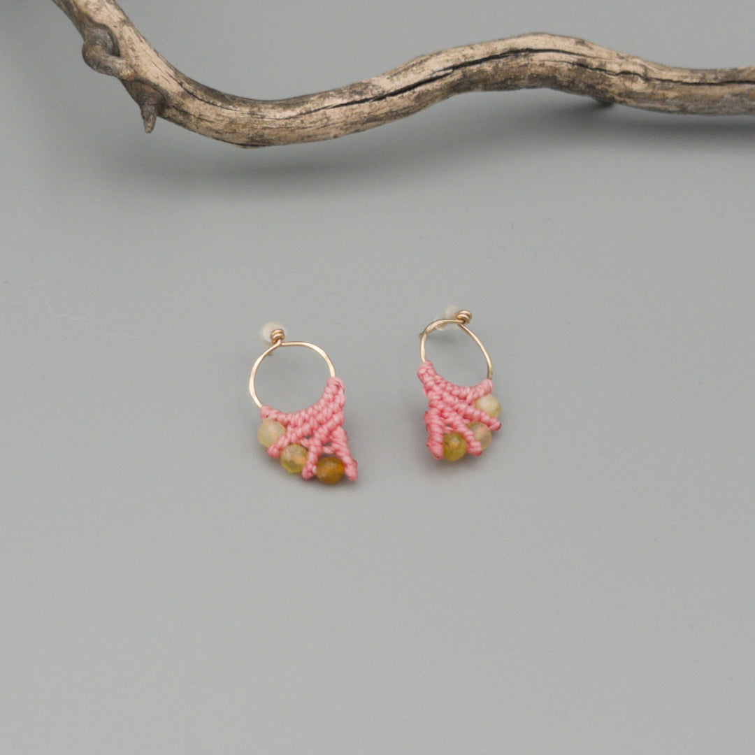 pink macrame earrings with yellow opal bead made with 14k gold fill on a gray background