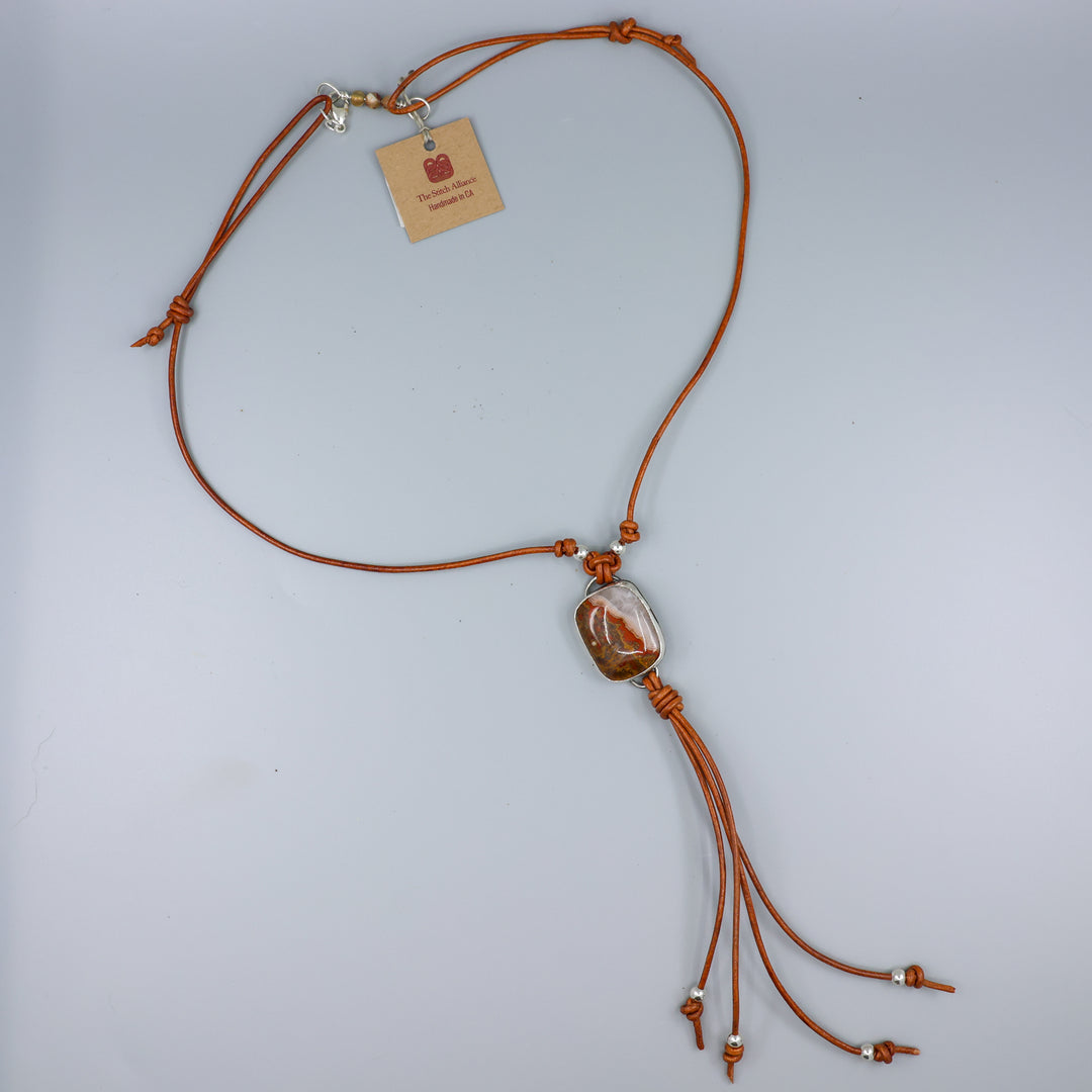 Mexican Agate Sterling Silver Bolo Style Necklace on a gray background