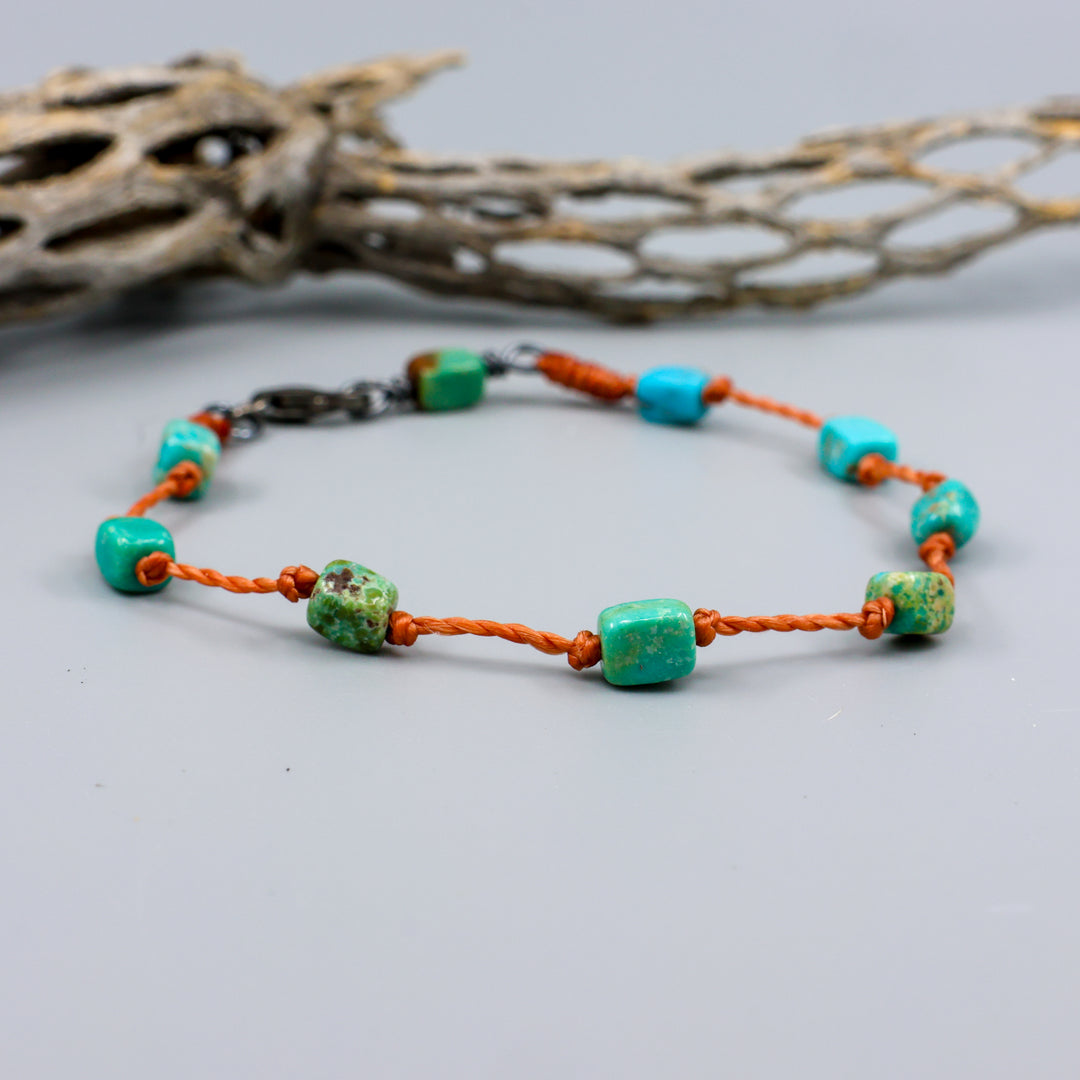 Handmade Turquoise bracelet on knotted terracotta cord with sterling silver clasp. 