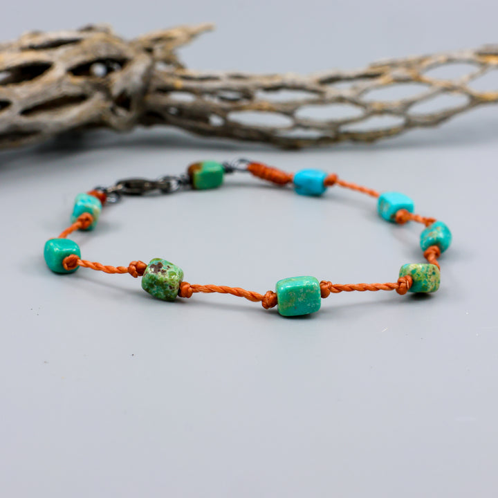 Handmade Turquoise bracelet on knotted terracotta cord with sterling silver clasp. 