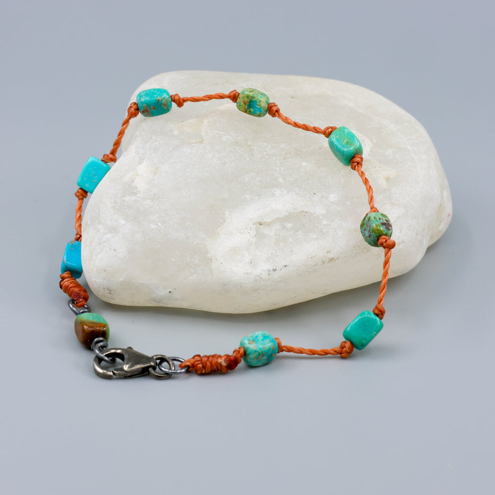 Turquoise bracelet on hand knotted terracotta cord with sterling silver clasp. 