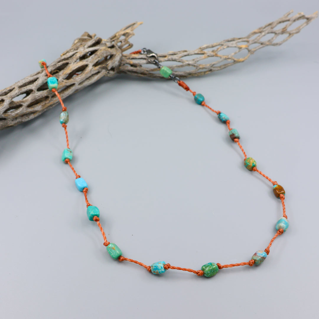 Handmade turquoise bead necklace on hand knotted terracotta cord with an oxidized sterling silver clasp