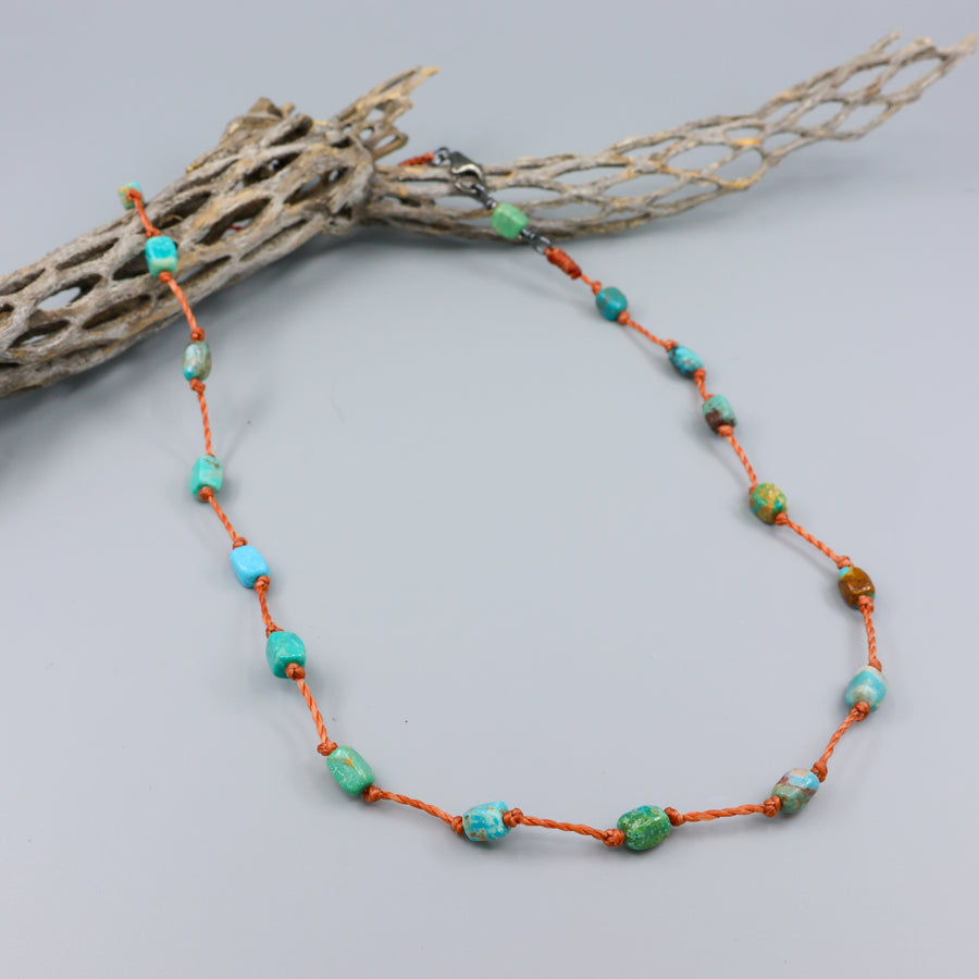 Handmade turquoise bead necklace on hand knotted terracotta cord with an oxidized sterling silver clasp
