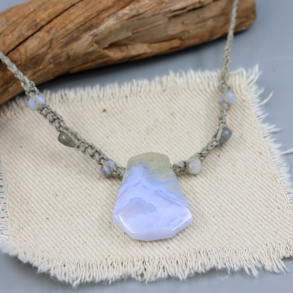 handmade blue lace agate macrame necklace on an off white background