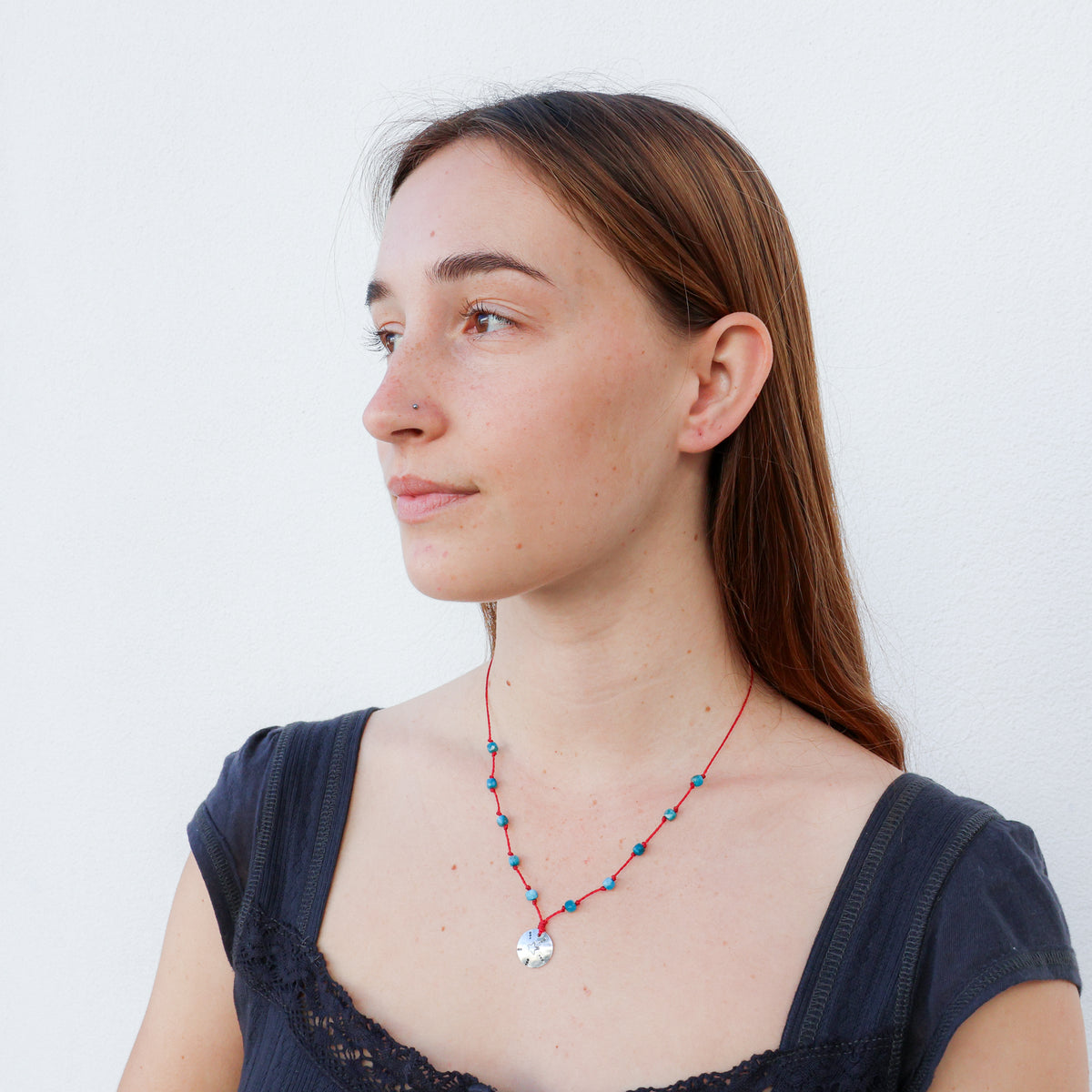 handmade sterling silver and blue apatite necklace on a red cord